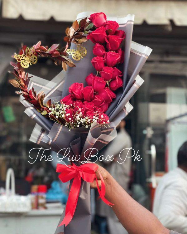 Heart-shaped bouquet with red roses and petals – romantic gift by Gift Shop Islamabad, gift shop in Islamabad.