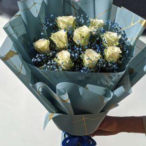 White roses bouquet in blue wrap – premium floral gift for him by Gift Shop Islamabad, flower shop in Islamabad.