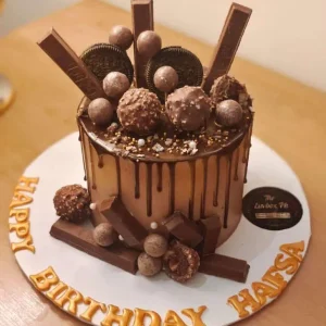 Luxury chocolate cake topped with KitKat, Dairy Milk, and Ferrero – best chocolate cake in Islamabad by Gift Shop Islamabad.